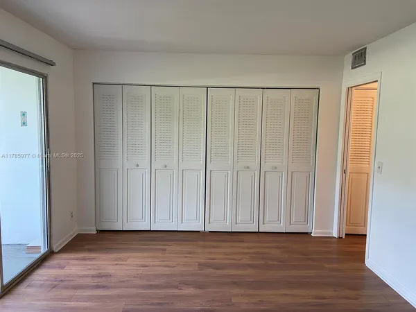 a view of wooden floor and entryway in a room