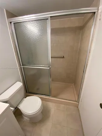 a bathroom with a toilet and shower