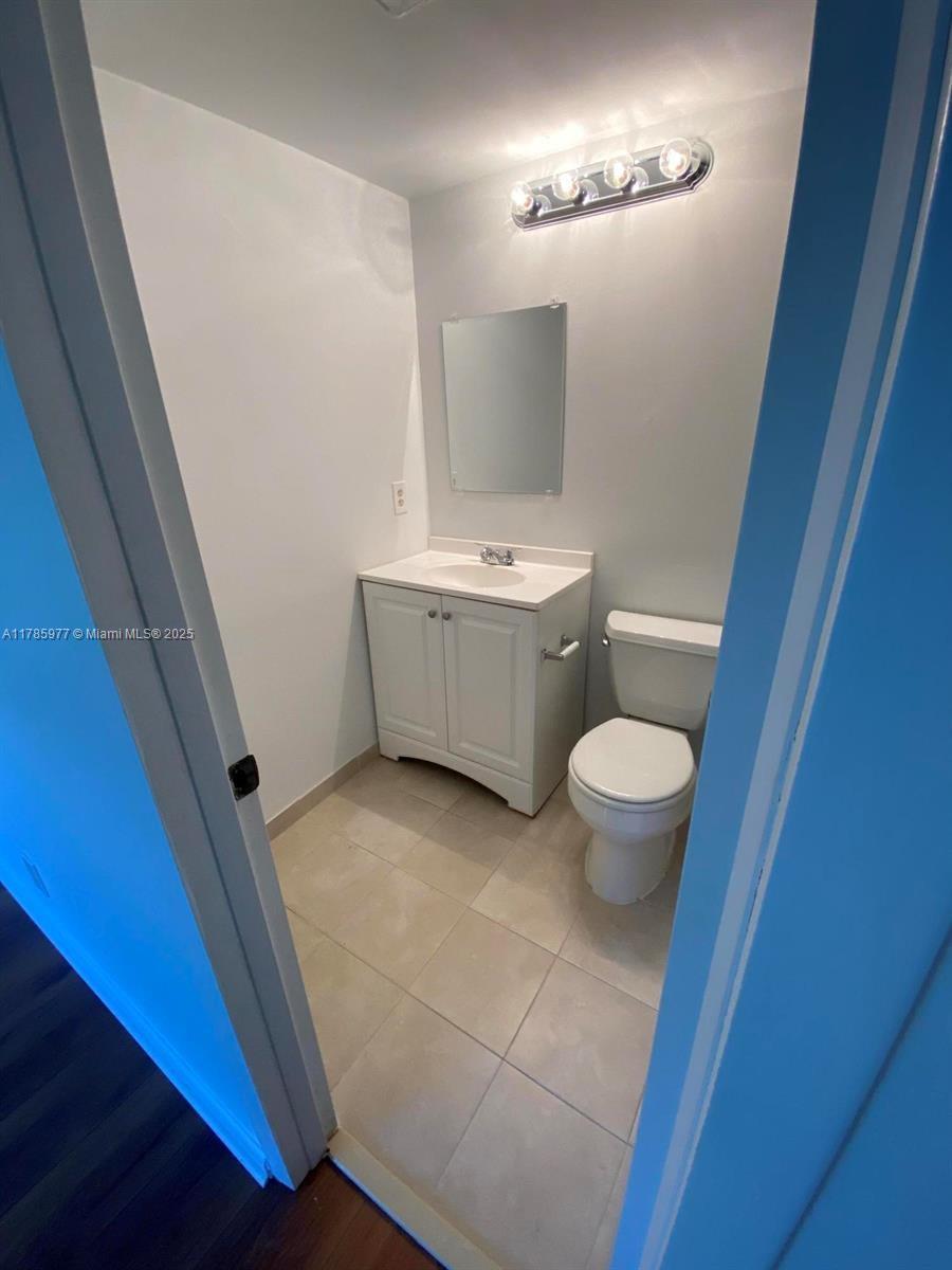 381 Fanshaw J, Unit 381 Boca Raton, FL 33434 - Photo 10 of 13 a bathroom with a sink and a mirror