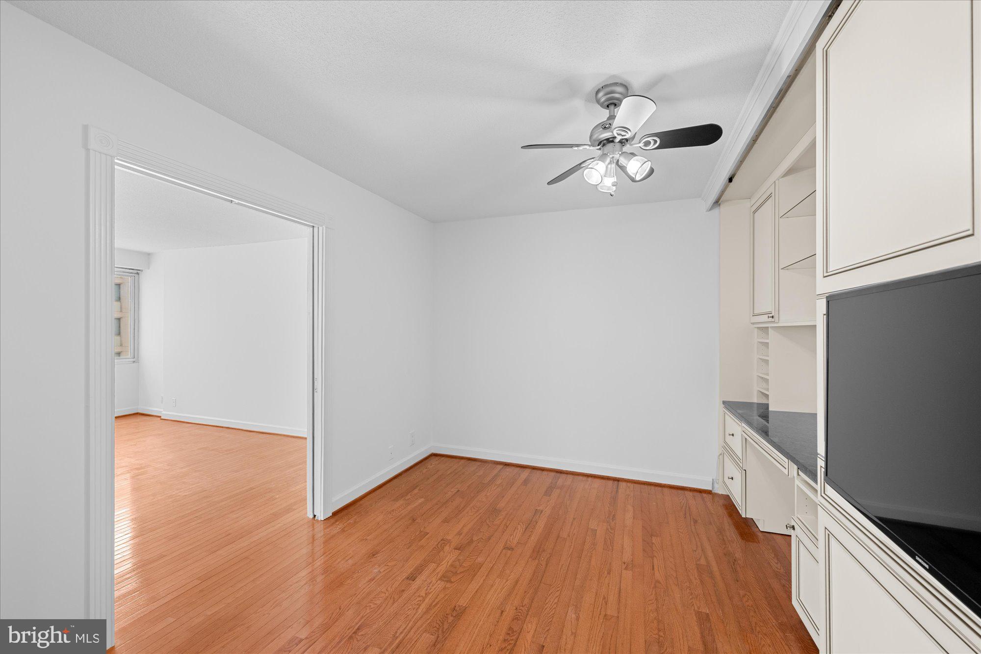 5500 Friendship Boulevard, Unit 2114N Chevy Chase, MD 20815 - Photo 13 of 19 wooden floor in an empty room with a kitchen