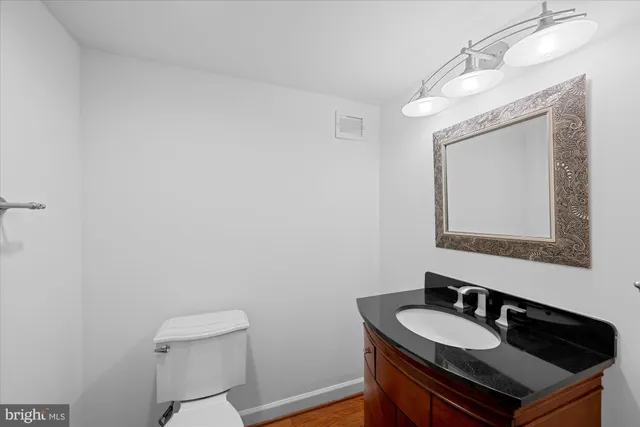 a bathroom with a sink a toilet and mirror