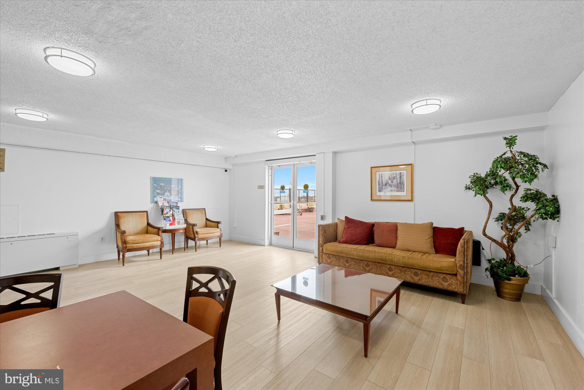5500 Friendship Boulevard, Unit 2114N Chevy Chase, MD 20815 - Photo 15 of 19 a living room with furniture a potted plant and a table