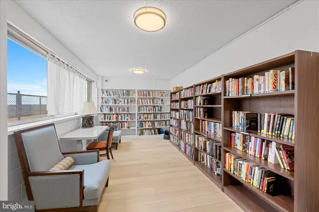 a living room with a book shelf and a book shelf
