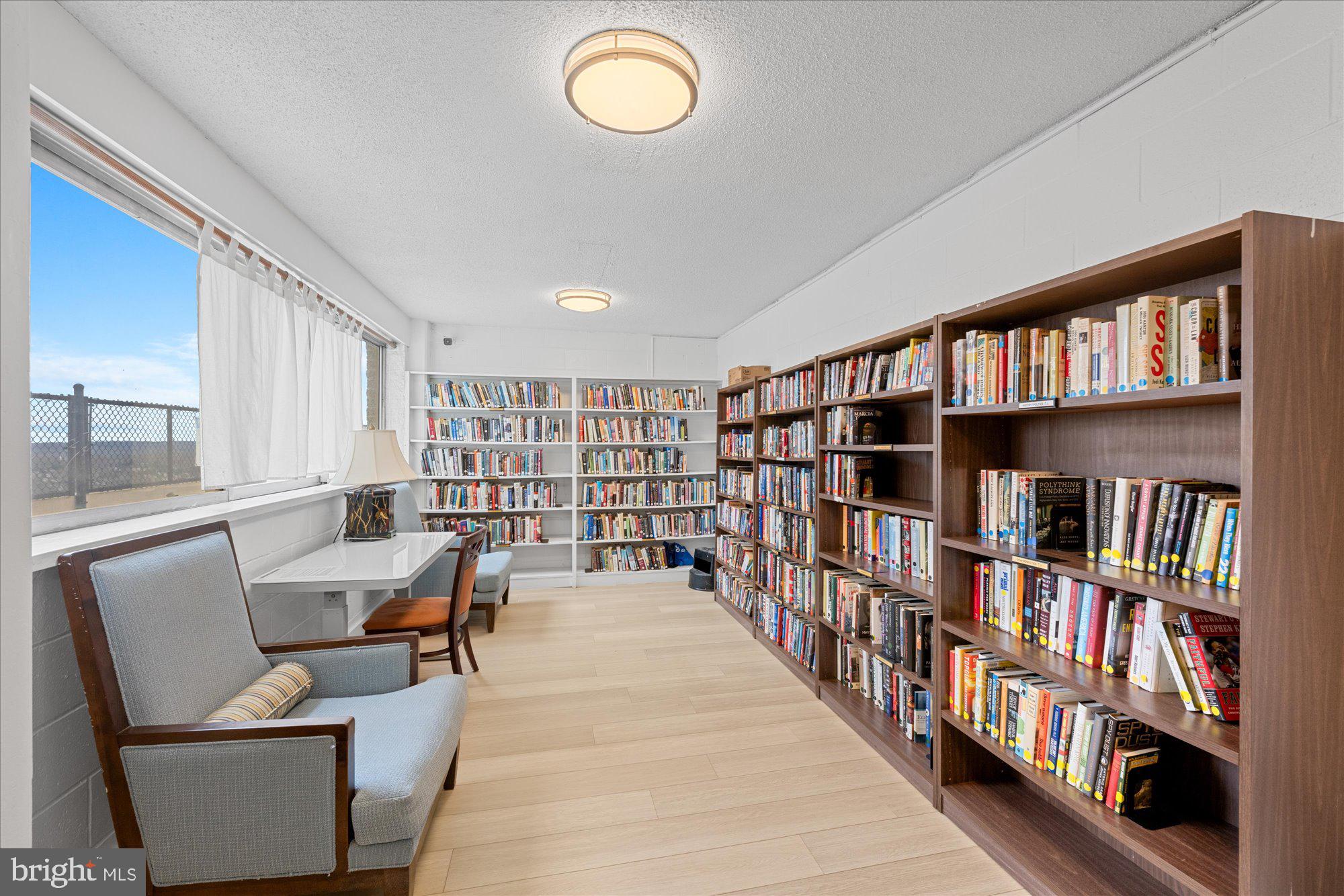 5500 Friendship Boulevard, Unit 2114N Chevy Chase, MD 20815 - Photo 16 of 19 a living room with a book shelf and a book shelf