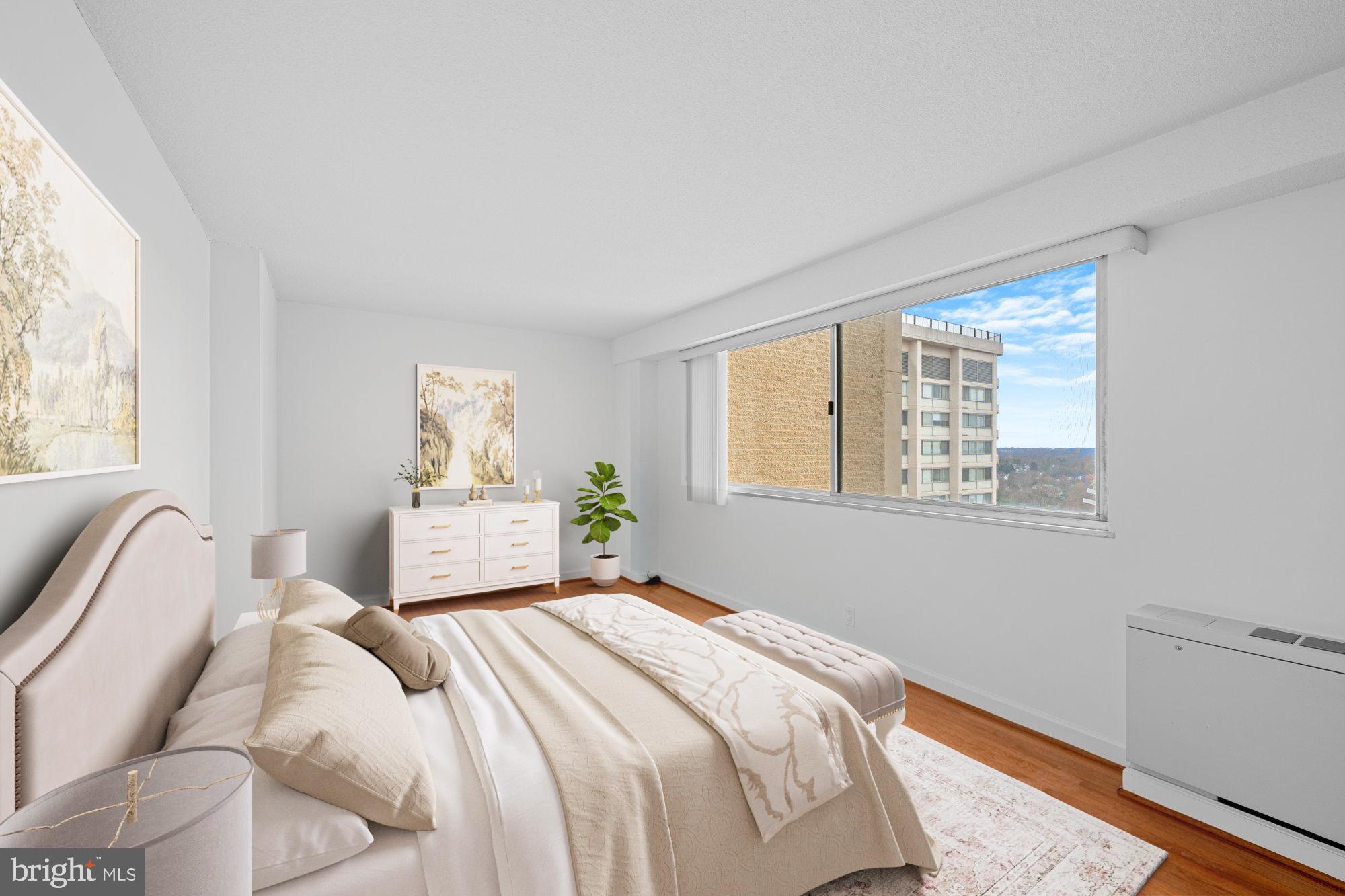 5500 Friendship Boulevard, Unit 2114N Chevy Chase, MD 20815 - Photo 10 of 19 a bedroom with a bed and wooden floor