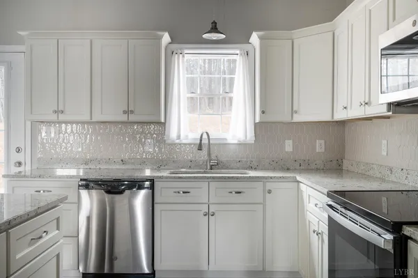 a kitchen with appliances cabinets and a sink