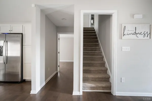 a view of a hallway with entryway wooden floor and staircase