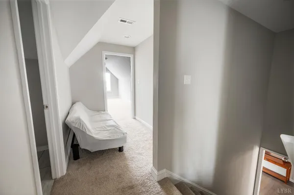 a bedroom with a bed and a mirror