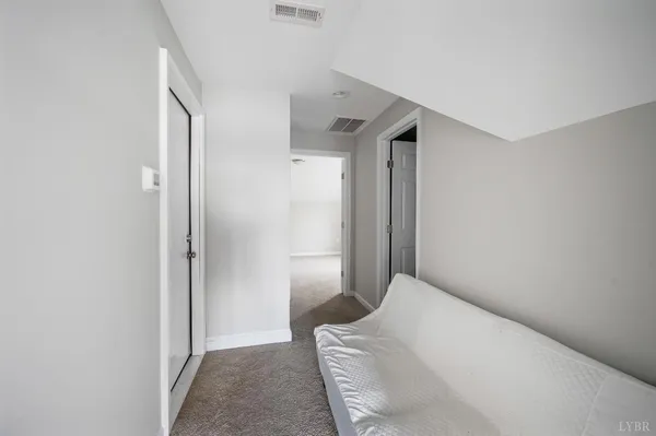 a bedroom with a bed and a rug