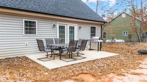 a view of a patio with a table and chairs