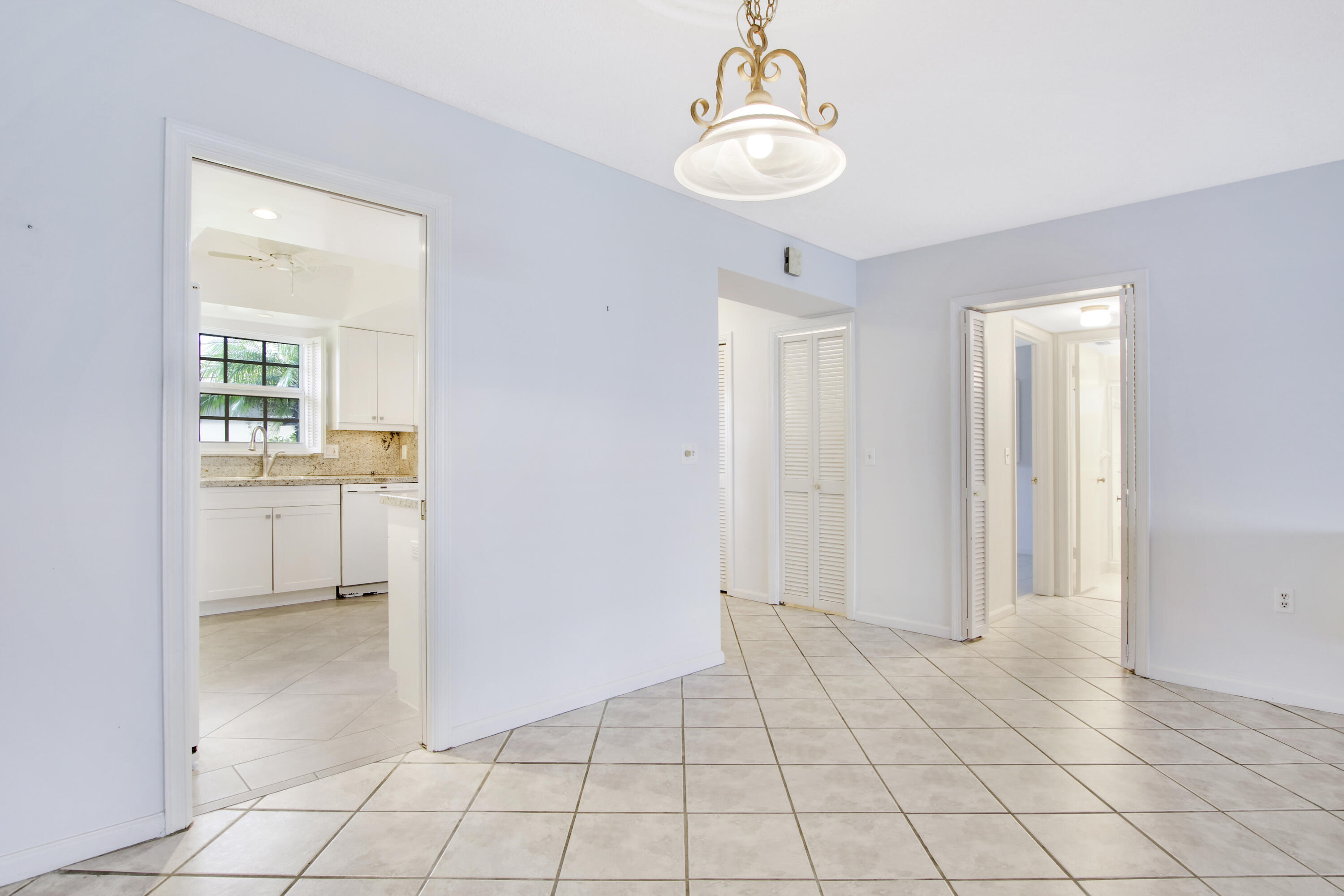 145 Atlantis Boulevard, Unit 105 Atlantis, FL 33462 - Photo 11 of 28 a view of an empty room with a window