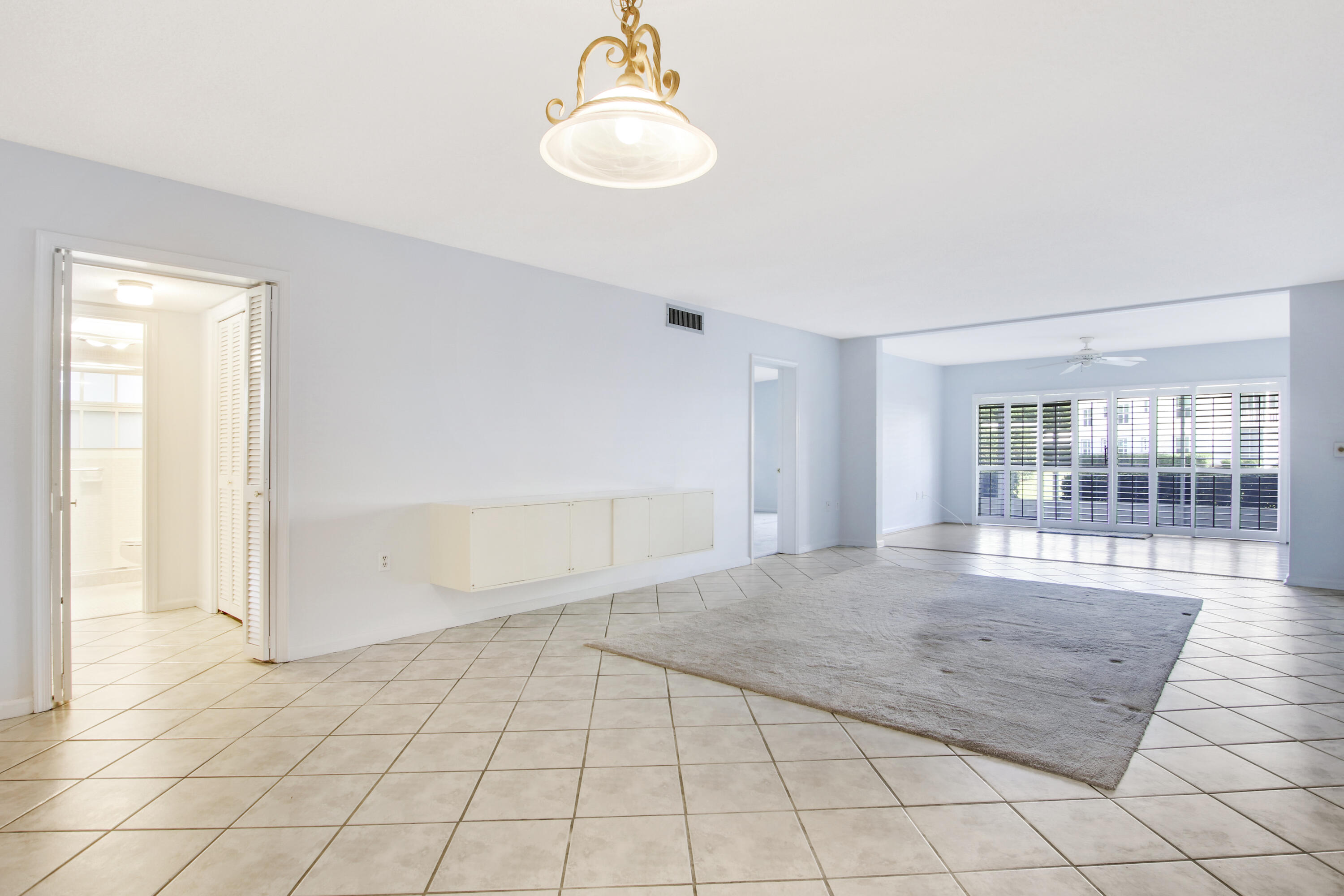 145 Atlantis Boulevard, Unit 105 Atlantis, FL 33462 - Photo 13 of 28 wooden floor in an empty room with a window
