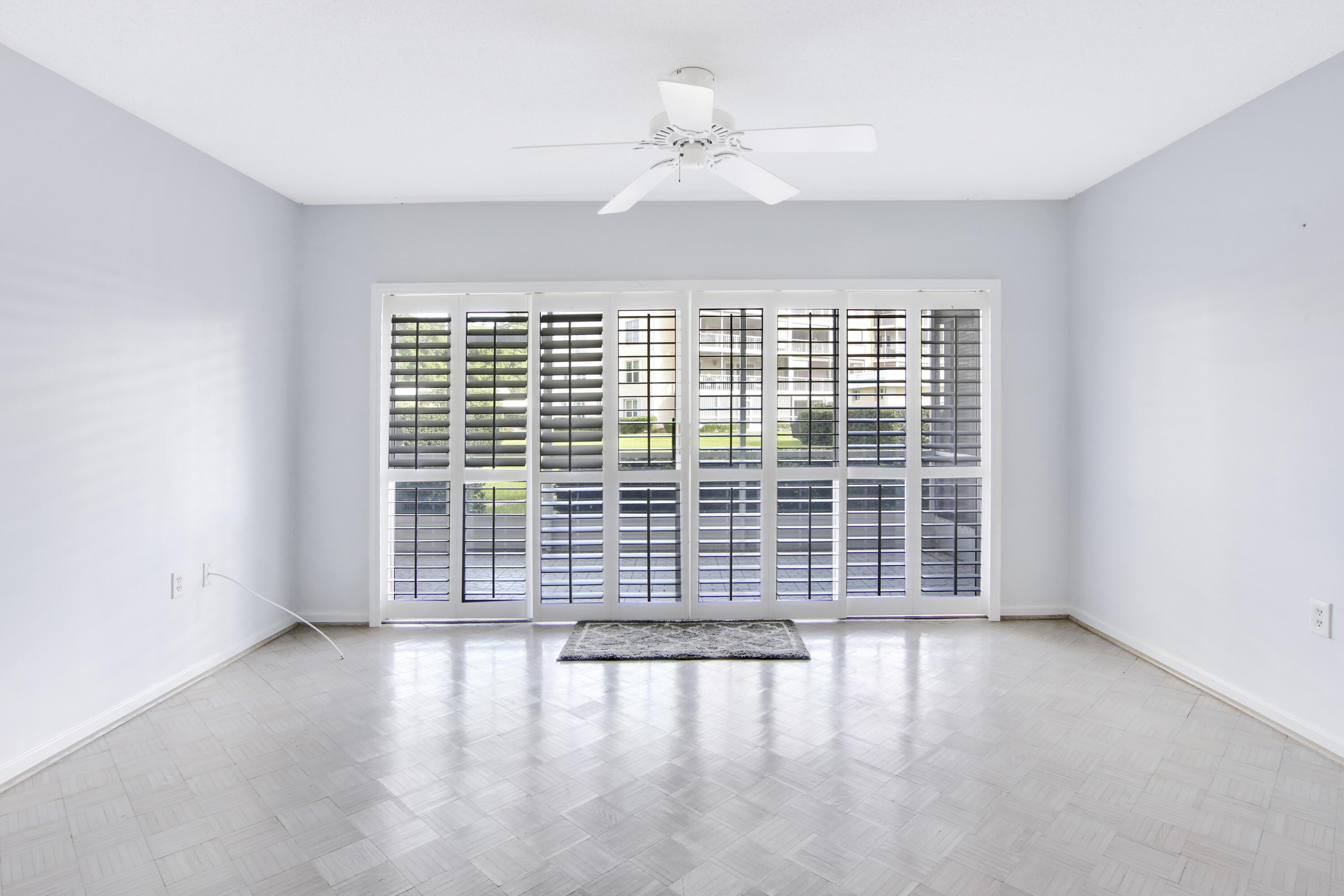 145 Atlantis Boulevard, Unit 105 Atlantis, FL 33462 - Photo 17 of 28 wooden floor in an empty room with a window