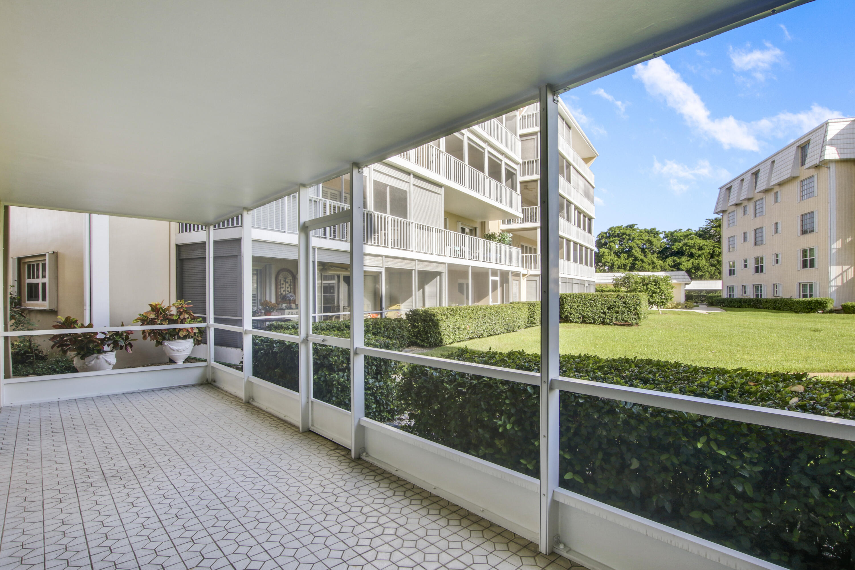 145 Atlantis Boulevard, Unit 105 Atlantis, FL 33462 - Photo 18 of 28 a view of building with yard