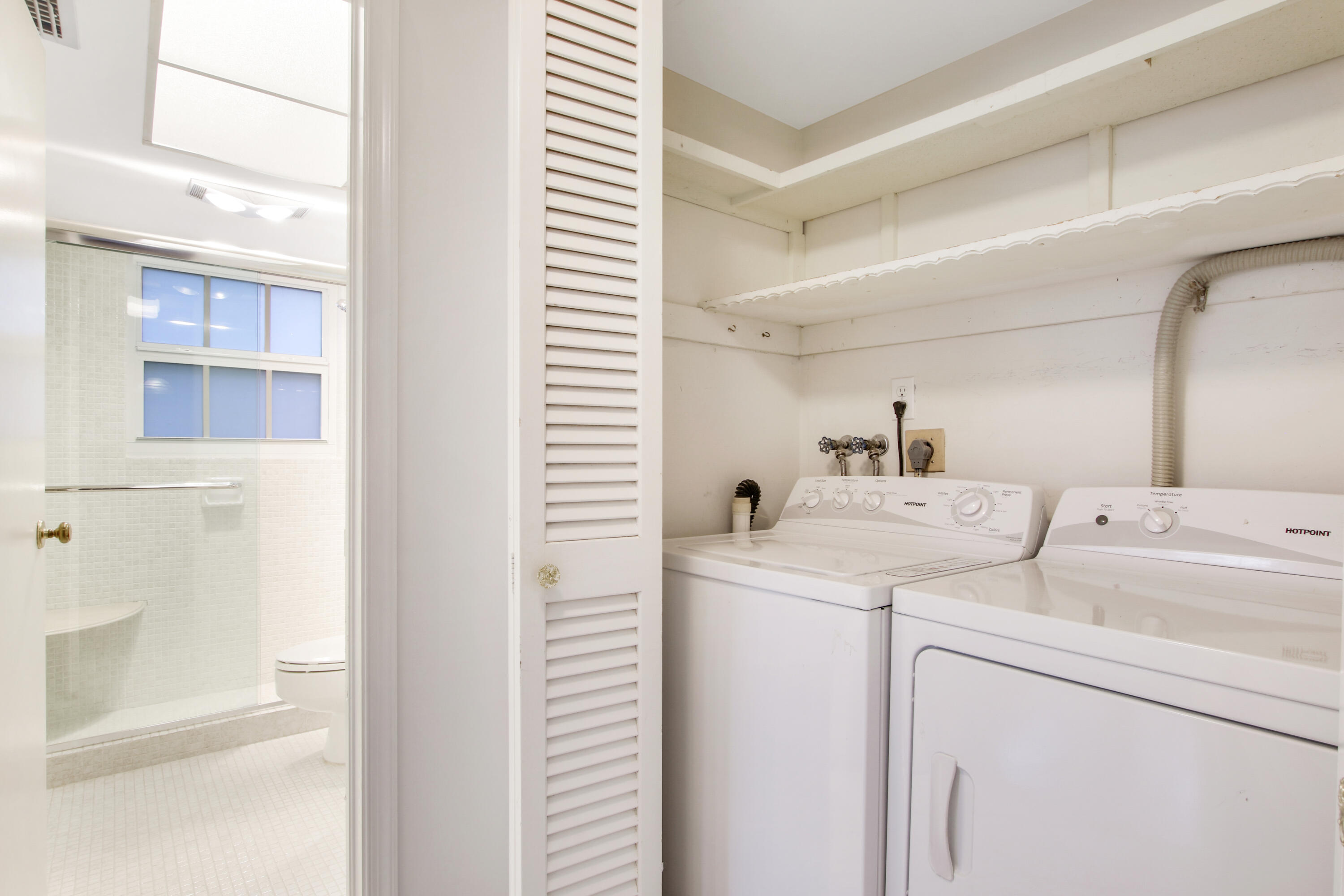 145 Atlantis Boulevard, Unit 105 Atlantis, FL 33462 - Photo 21 of 28 a view of storage and utility room with washer and dryer