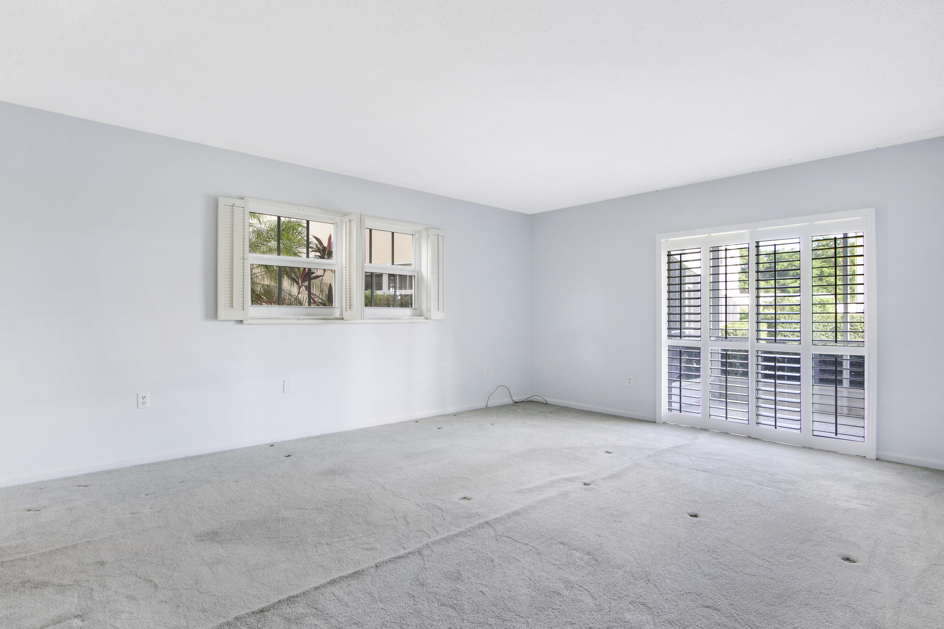145 Atlantis Boulevard, Unit 105 Atlantis, FL 33462 - Photo 25 of 28 an empty room with windows