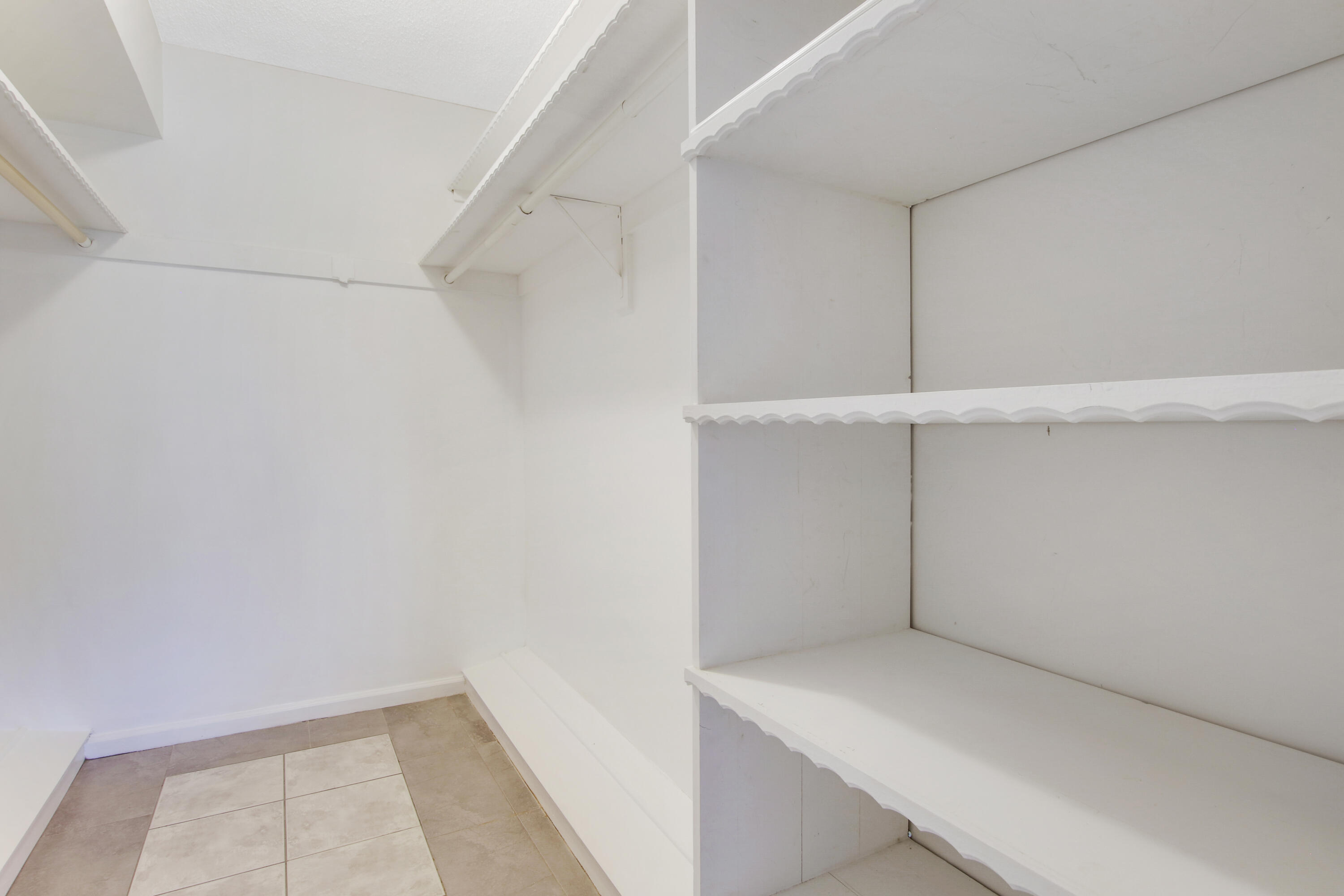 145 Atlantis Boulevard, Unit 105 Atlantis, FL 33462 - Photo 27 of 28 a view of an empty walk in closet