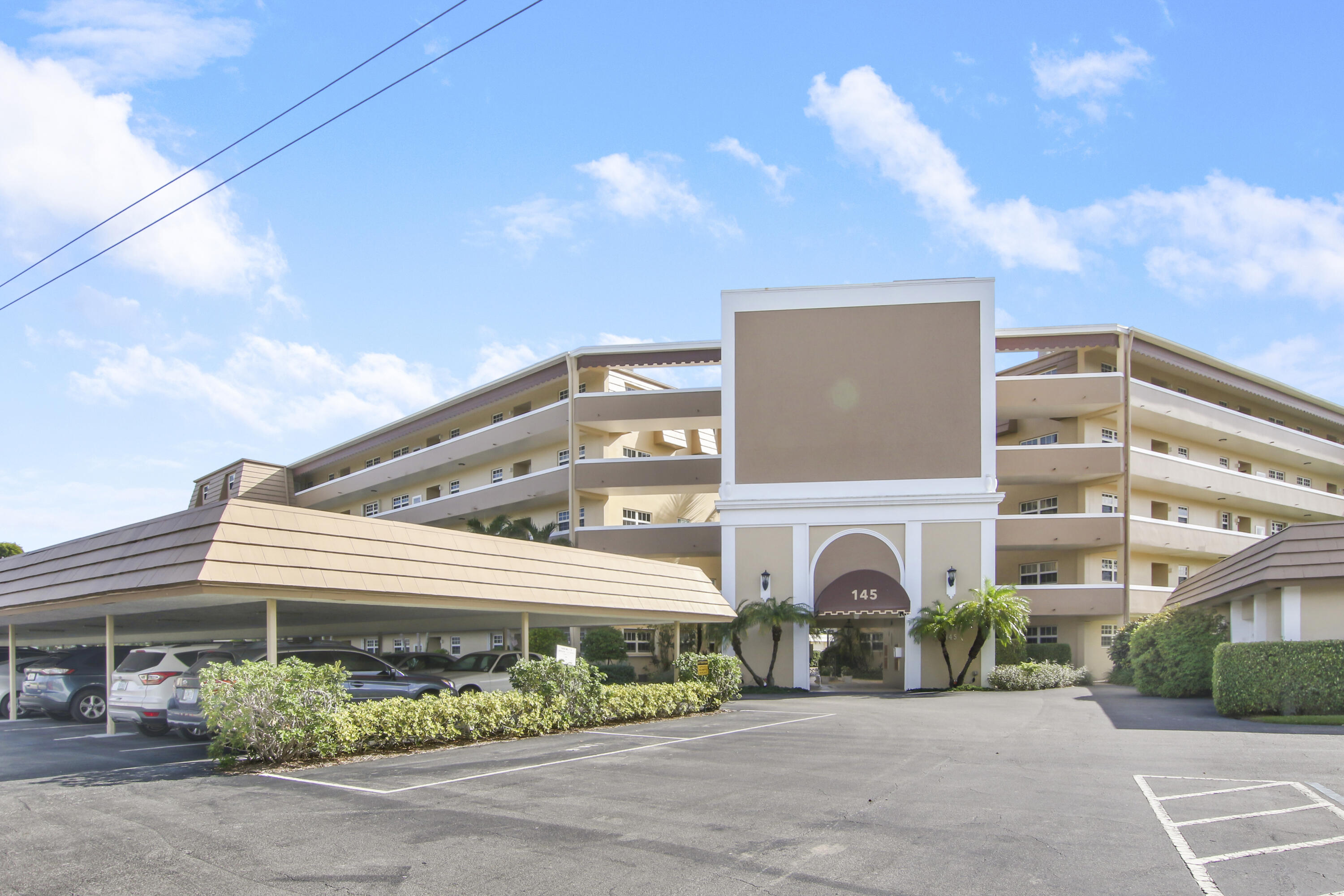 145 Atlantis Boulevard, Unit 105 Atlantis, FL 33462 - Photo 3 of 28 a front view of a building