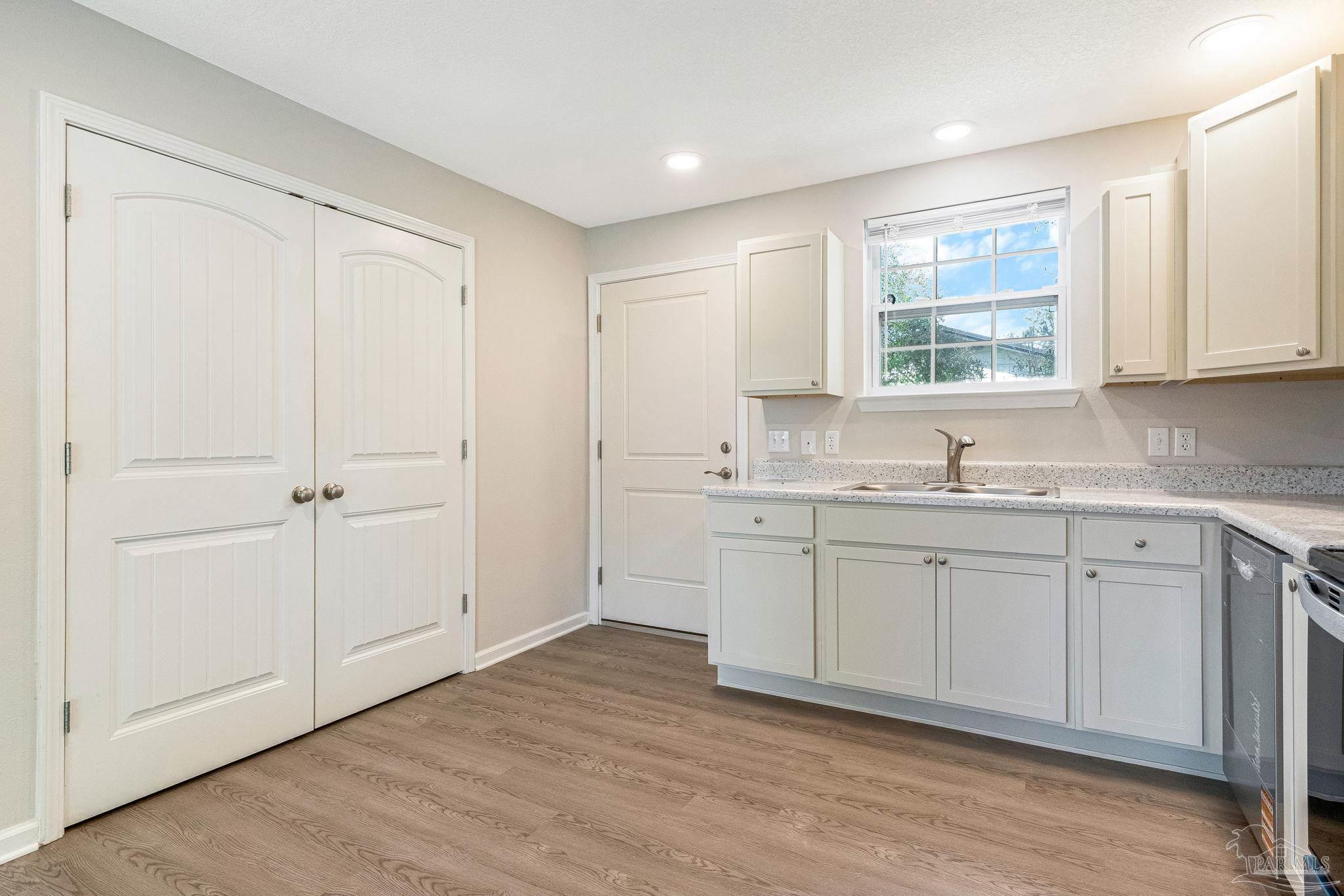 3152 Clemson Road Gulf Breeze, FL 32563 - Photo 11 of 56 a bathroom with a sink cabinets and a window
