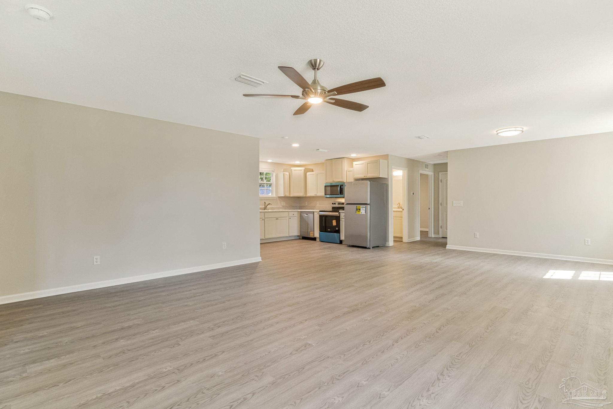 3152 Clemson Road Gulf Breeze, FL 32563 - Photo 14 of 56 a view of a kitchen with a sink and a refrigerator