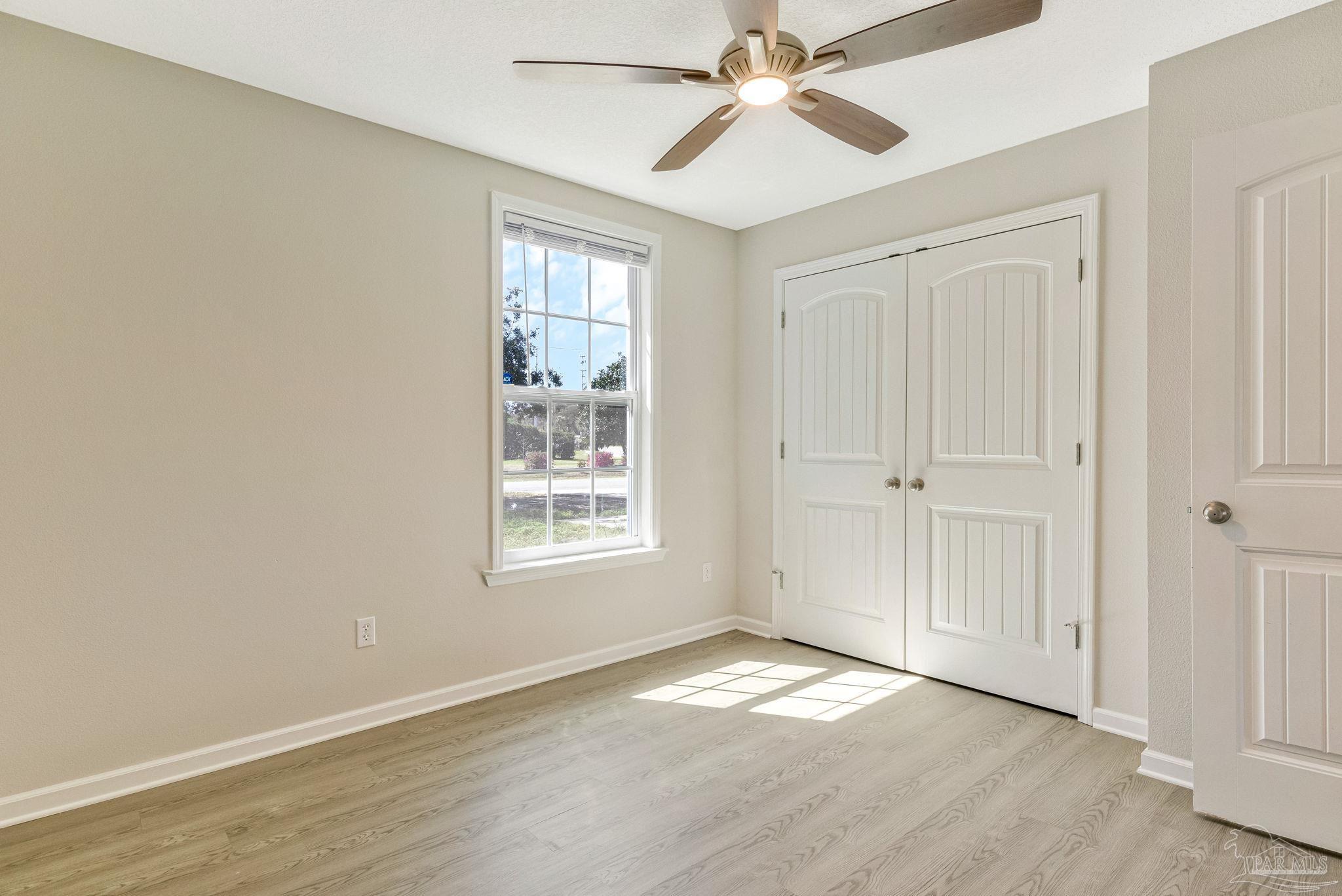 3152 Clemson Road Gulf Breeze, FL 32563 - Photo 19 of 56 a view of empty room with wooden floor and fan