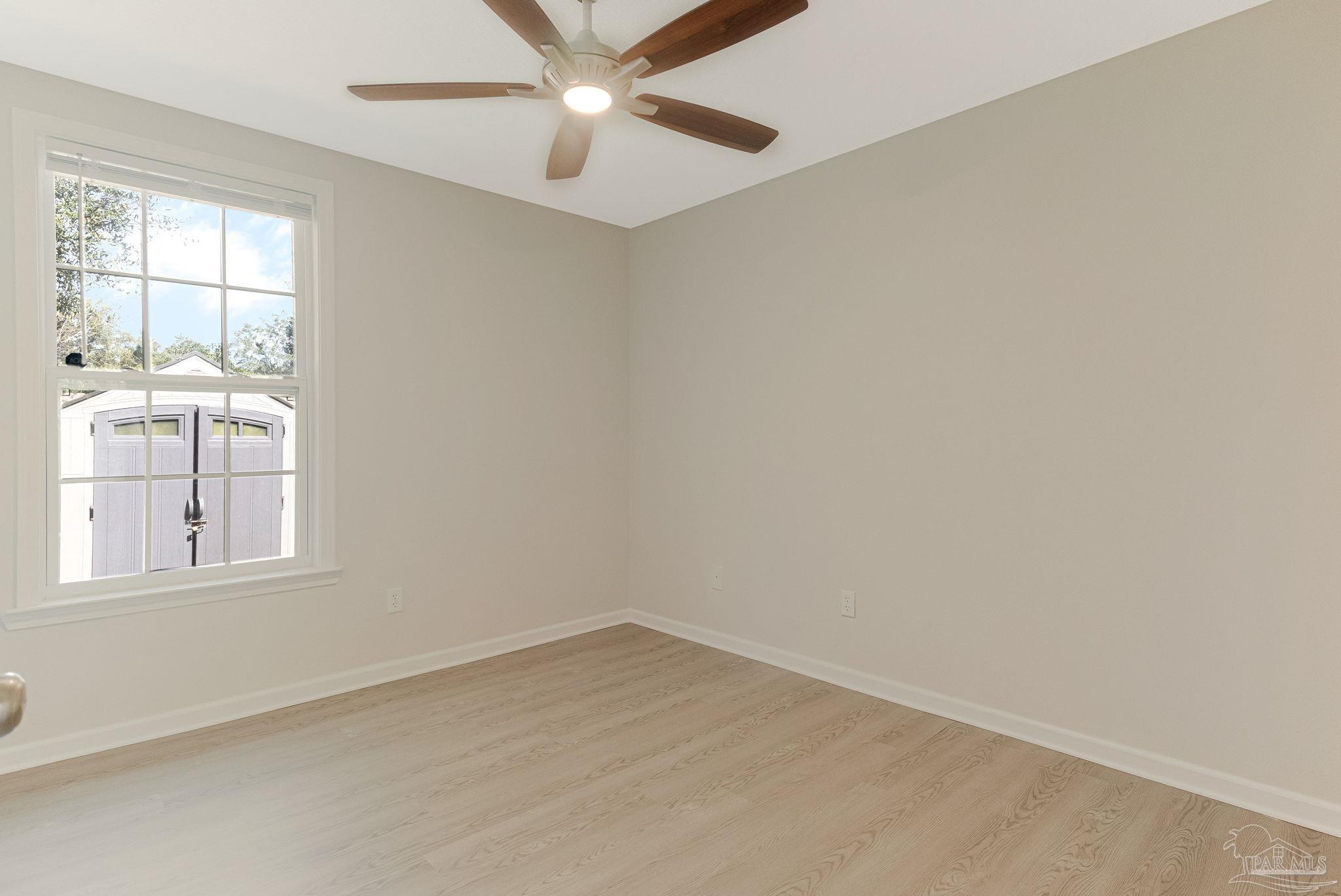3152 Clemson Road Gulf Breeze, FL 32563 - Photo 22 of 56 an empty room with windows and fan