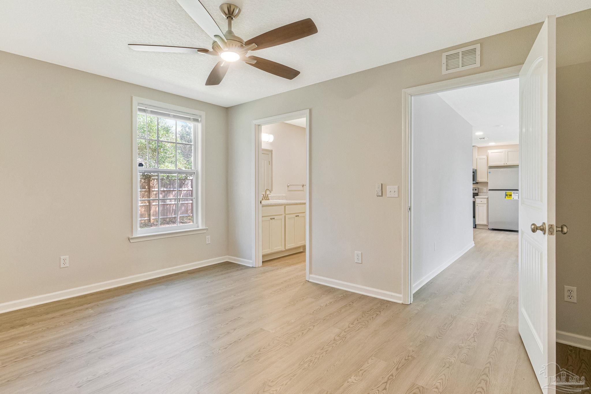 3152 Clemson Road Gulf Breeze, FL 32563 - Photo 24 of 56 wooden floor in an empty room with a window