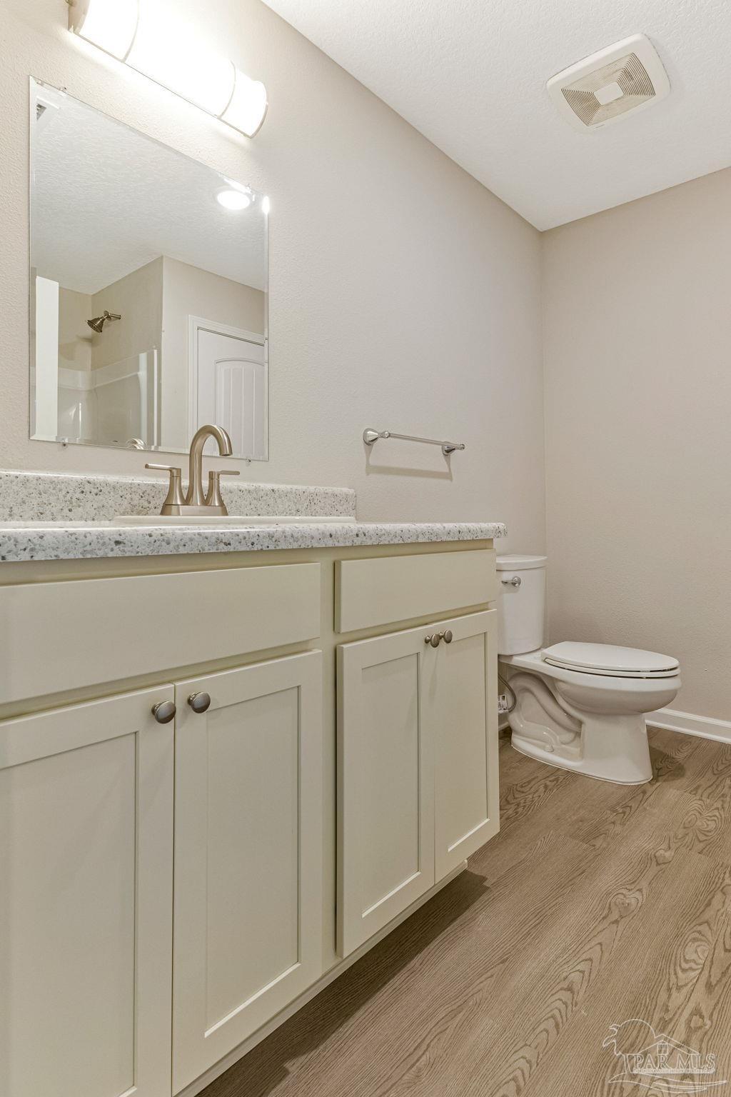 3152 Clemson Road Gulf Breeze, FL 32563 - Photo 28 of 56 a bathroom with a toilet a sink and mirror