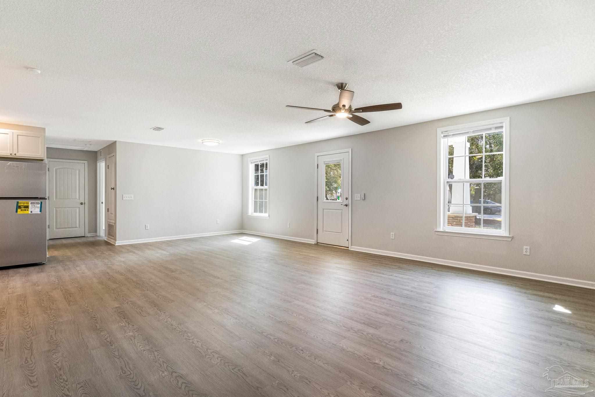 3152 Clemson Road Gulf Breeze, FL 32563 - Photo 3 of 56 a view of an empty room with a window and wooden floor
