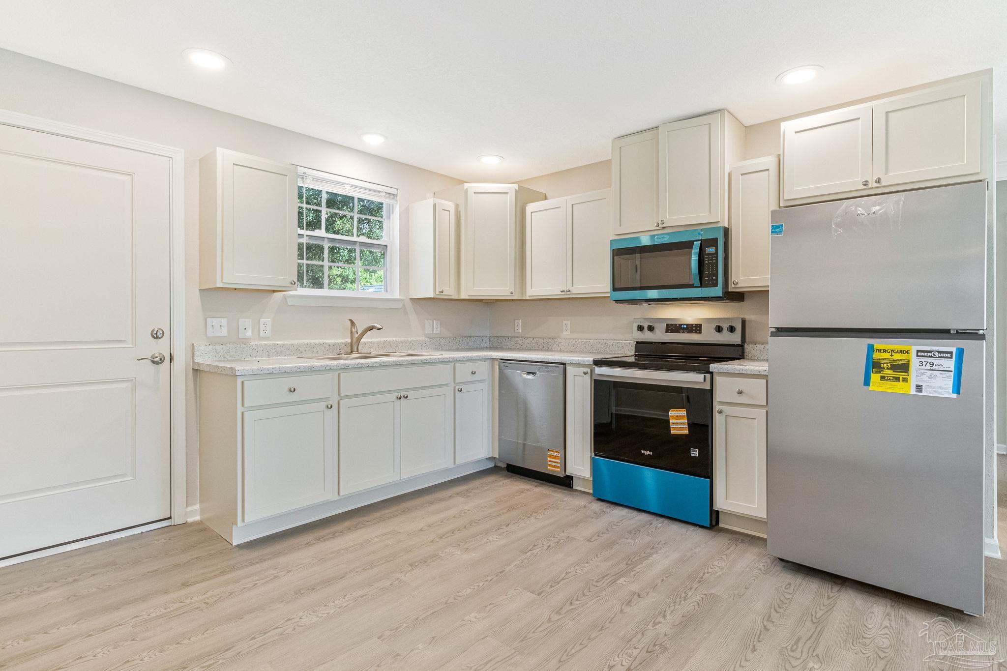 3152 Clemson Road Gulf Breeze, FL 32563 - Photo 4 of 56 a kitchen with appliances cabinets and a sink