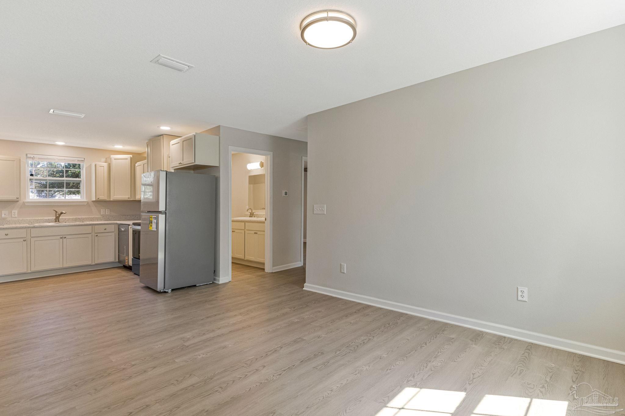 3152 Clemson Road Gulf Breeze, FL 32563 - Photo 9 of 56 a view of a kitchen with a sink and a refrigerator
