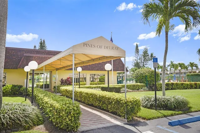 a view of a white house with a yard