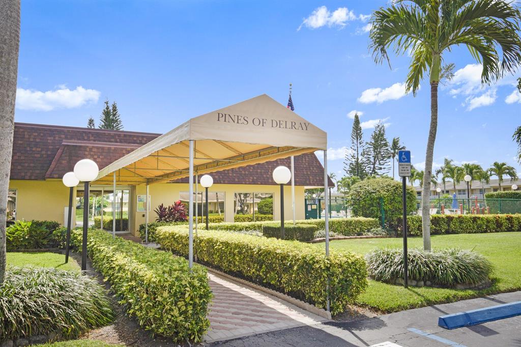 1141 Calamondin Terrace, Unit 202 Delray Beach, FL 33445 - Photo 19 of 19 a view of a white house with a yard