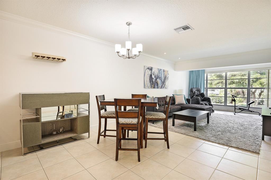 1141 Calamondin Terrace, Unit 202 Delray Beach, FL 33445 - Photo 5 of 19 a view of a dining room with furniture