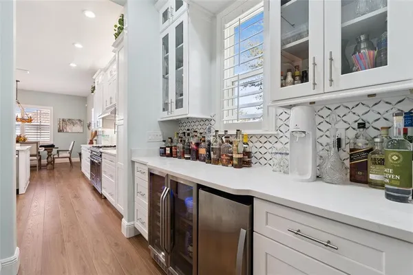 a kitchen with stainless steel appliances granite countertop a sink a stove and a wooden floors