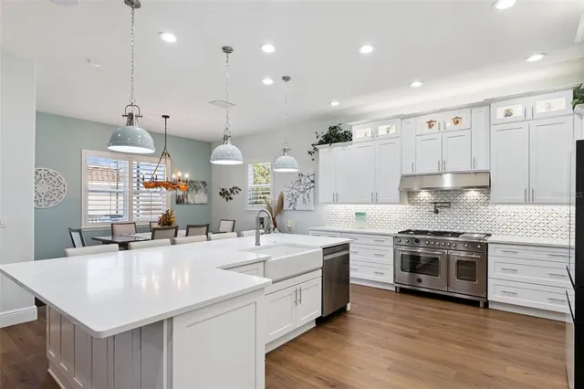 a dining room with furniture a rug and wooden floor