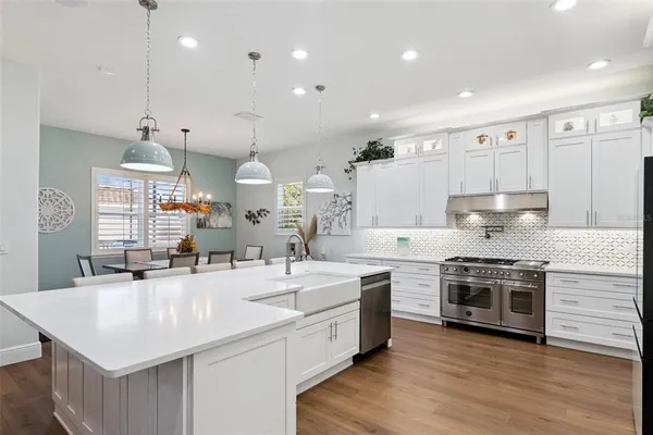 a dining room with furniture a rug and wooden floor