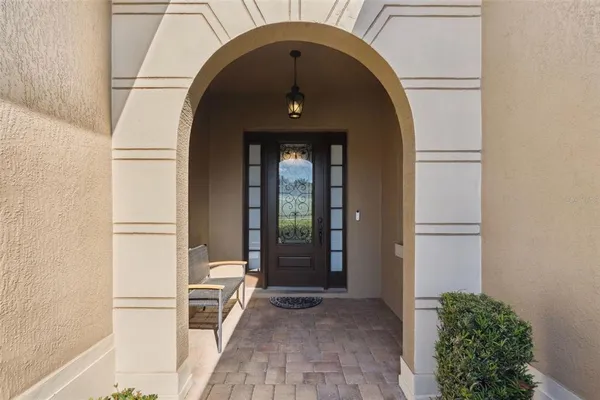 a view of a hallway to a livingroom and a front door