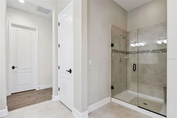 a view of a hallway with closet and wooden floor