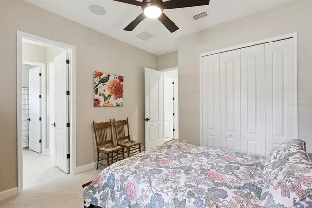 a living room with patio furniture and a floor to ceiling window