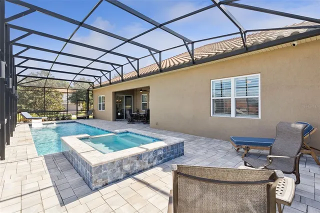 an aerial view of a house with a garden and houses