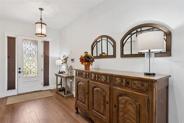 a living room with furniture and large windows