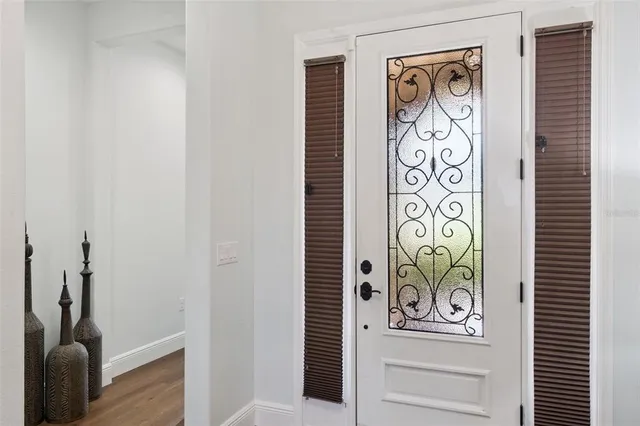 a living room with furniture kitchen view and a wooden floor