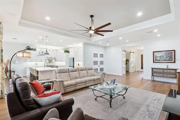 a living room with furniture and wooden floor