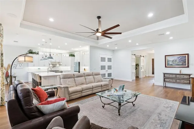 a living room with furniture and wooden floor