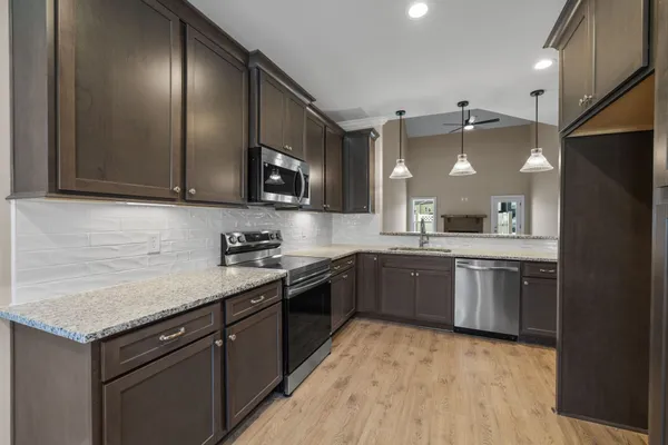 a kitchen with a sink a stove and cabinets