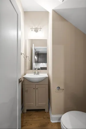 a bathroom with a sink toilet and mirror
