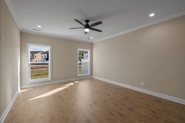wooden floor in an empty room with a window