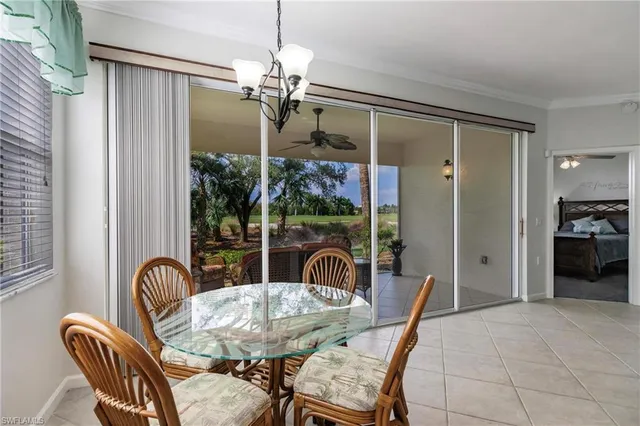 a view of a dining room with furniture wooden floor livingroom and chandelier
