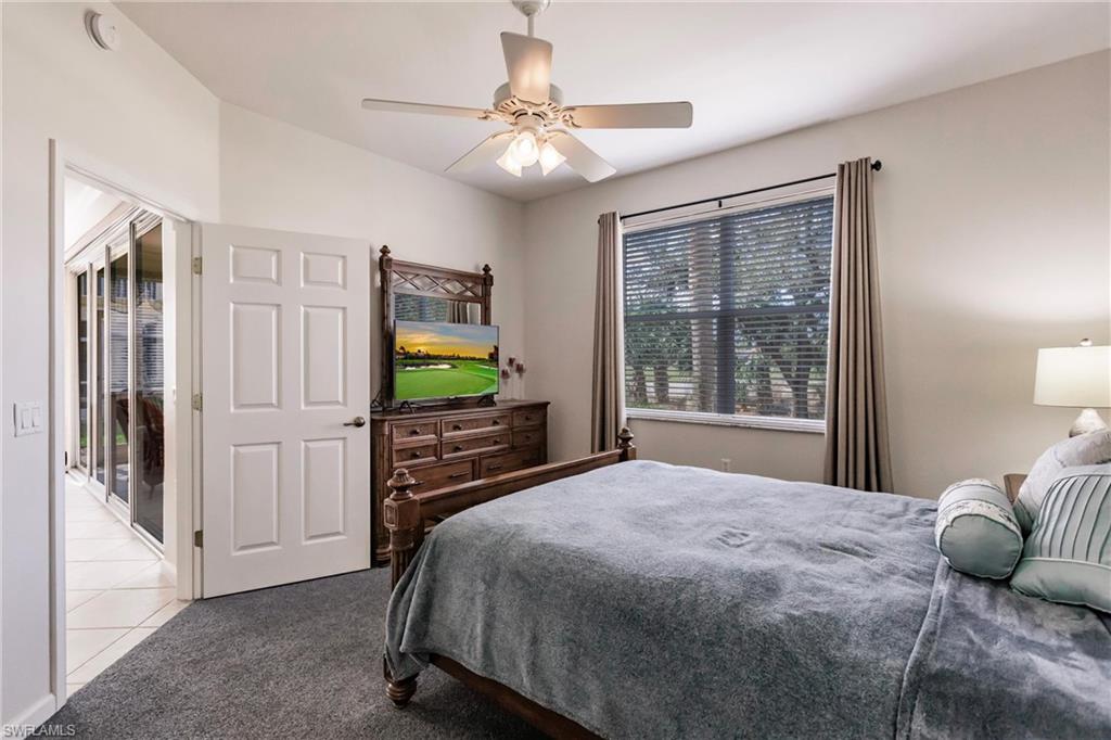 3071 Meandering Way, Unit 101 Fort Myers, FL 33905 - Photo 17 of 49 a bedroom with a bed and a flat screen tv